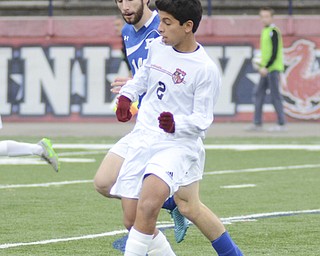 Katie Rickman | The Vindicator.Canfield's  Justin Montazeri (#2) Poland's Evan Rumble(#16) comes up from behind attempting to block his path during the game in Niles on Saturday night.