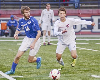 Katie Rickman | The Vindicator. Poland's Evan Rumble(#16) and Canfield's Justin Jickess race for the ball during the game in Niles on Saturday night.