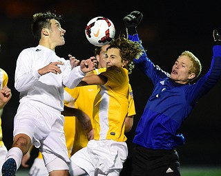 SANDUSKY, OHIO - NOVEMBER 11, 2015: Landon Baer #6 of South Range attempts to head the ball into the net while the Archbold defense of Denver Beck #4 and Elijah Robison #1 prevent the shot from finding the net during the 1st half of Wednesday nights State Semi-Final game at Cedar Point Stadium. Out Range won 1-0. DAVID DERMER | THE VINDICATOR