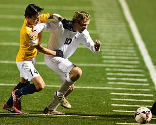 SANDUSKY, OHIO - NOVEMBER 11, 2015: Brandon Youngs #10 of South Range is grabbed from behind by Josh Kidder #14 of Archbold during the 2nd half of Wednesday nights State Semi-Final game at Cedar Point Stadium. Out Range won 1-0. DAVID DERMER | THE VINDICATOR
