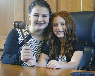Katie Rickman | The Vindicator.Sisters Desi Allen 12 and her newly adopted sister Vada 8 hold the gavel as they smile for photos after adoption proceedings at the Trumbull Country Courthouse during Adoption Month celebrations on Friday, November 13, 2015.