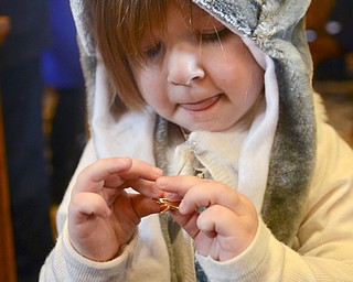 Katie Rickman | The Vindicator.Sazah (OKAY) Markovich looks down at a pendant that was a gift, it included the date of her adoption to Todd and Jodi Markovich and was presented to her after adoption proceedings at the Trumbull Country Courthouse during Adoption Month celebrations on Friday, November 13, 2015.
