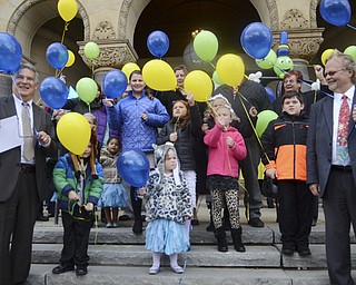 Katie Rickman | The Vindicator.Adoptive families and others gather for a photo on the courthouse steps after adoption proceedings at the Trumbull Country Courthouse during Adoption Month celebrations on Friday, November 13, 2015.