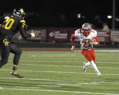       .         ROBERT  K. YOSAY | THE VINDICATOR..Labrae #22  Arjay Oliver takes off for a small gain as Crestviews #20 Jordan Murphy heads him into the sidelines..LaBrae VS Crestview..-30-