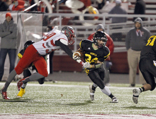       .         ROBERT  K. YOSAY | THE VINDICATOR..Crestviews #34 Zach Hicks breaks ot of the bacfield and th clutches of #59 LaBrae alton Stout as he heads ofr a TD..LaBrae VS Crestview..-30-