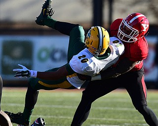 YOUNGSTOWN, OHIO - NOVEMBER 14, 2015: Darrius Shepherd #20 of North Dakota State is thrown down to the turf by Jameel Smith #26 of YSU during the 1st half of their game at Stambaugh Stadium Saturday afternoon. DAVID DERMER | THE VINDICATOR