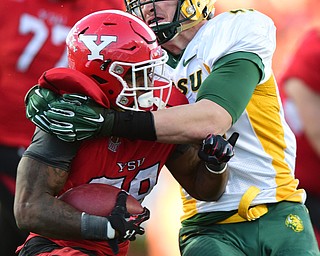YOUNGSTOWN, OHIO - NOVEMBER 14, 2015: Martin Ruiz #28 of YSU is brought down by Dan Marlette #48 of North Dakota State during the 2nd half of their game at Stambaugh Stadium Saturday afternoon. DAVID DERMER | THE VINDICATOR