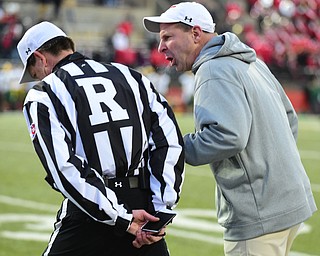 YOUNGSTOWN, OHIO - NOVEMBER 14, 2015: Bo Pelini of YSU screams into the ear of referee Matt Gallagher after a pass interference call on 4th down gave North Dakota State a 1st down and a NDSU touchdown a few plays later during the 4th quarter of their game at Stambaugh Stadium Saturday afternoon. DAVID DERMER | THE VINDICATOR