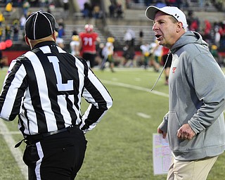 YOUNGSTOWN, OHIO - NOVEMBER 14, 2015: Bo Pelini of YSU tracks down line judge Gregory Allen after the conclusion of the football game Saturday evening at Stambaugh Stadium Saturday afternoon. DAVID DERMER | THE VINDICATOR