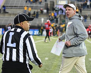 YOUNGSTOWN, OHIO - NOVEMBER 14, 2015: Bo Pelini of YSU tracks down line judge Gregory Allen after the conclusion of the football game Saturday evening at Stambaugh Stadium Saturday afternoon. DAVID DERMER | THE VINDICATOR