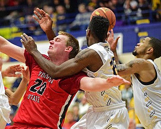KENT, OHIO - NOVEMBER 14, 2015: Bobby Hain #20 of YSU falls to the ground after taking a forearm from Galal Cancer #15 of Kent State to the face while they both were going for a rebound during the 2nd half of Saturday nights game at the Memorial Athletic and Convocation Center. Kent State won 79-70. DAVID DERMER | THE VINDICATOR
