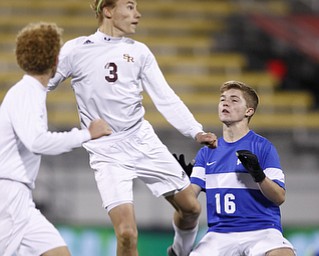 Canfield South Range's Cole Frank, center, heads the ball between teammate Brooks Thomas, left, and  Cincinnati Summit Country Day's Sam Smallwood during the second half of the boys Division III Ohio State Soccer Championship Saturday, Nov. 14, 2015, in Columbus, Ohio. Cincinnati Summit Country Day won 9-0. (Photo/Paul Vernon)