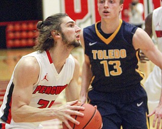 William D Lewis the VindicatorYSU's Jordan Andrews(25) shoots over Toledo's Jaelan Sanford(13) during 11-18-15 action at YSU.