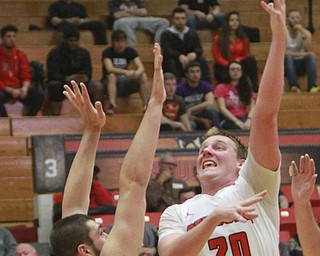 William D Lewis the VindicatorYSU's Bobby Hain(20) shootsover Toledo's NAthan Boothe during 11-18-15 action at YSU.