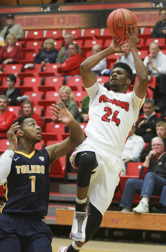 William D Lewis the VindicatorYSU's Cameron Morse(24 shoots over Toledo's Jonathon williams(1) during 11-18-15 action at YSU.