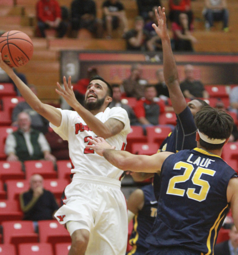 William D Lewis the Vindicator YSU's Franciscosantiago (23) shoots past Toledo's Jordan Lauf(25) during 11182015 game.
