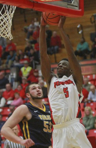 William D Lewis the VindicatorYSU's Sidney Umude(5) shootsover Toledo's NAthan Boothe during 11-18-15 action at YSU.