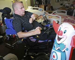 William D. Lewis The Vindicator As a stress reliever Rev. Steve Popovich  takes a swing at an inflatable Bozo the Clown in his room at Liberty Healthcare and Rehab. Popovich was paralized in a car crash and residing and undergoing therapy at the Liberty facility .