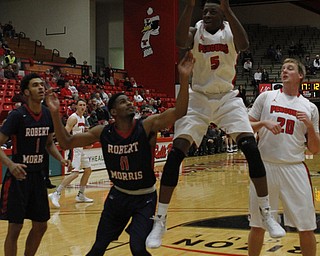 Youngstown State's Sidney Umude (5) jumps for a rebound over Rodney Pryor (11) of Robert Morris during the first half of Wednesday nights matchup at the Beeghly Center.  Dustin Livesay  |  The Vindicator  12/2/15  Beeghly Center