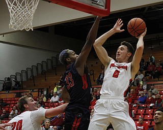 Youngstown State's Matt Donlan (0) drives in for a layup while being defended by Andre Frederick (33) of Robert Morris during the first half of Wednesday nights matchup at the Beeghly Center.  Dustin Livesay  |  The Vindicator  12/2/15  Beeghly Center