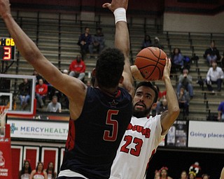 Youngstown State's Francisco Santiago (23) tries to shoot while being closely defended by Elijah Minnie (5) of Robert Morris during the first half of Wednesday nights matchup at the Beeghly Center.  Dustin Livesay  |  The Vindicator  12/2/15  Beeghly Center