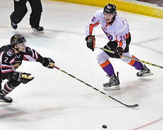 YOUNGSTOWN, OHIO _ DECEMBER 2, 2015: Cameron Morrison #26 of the Phantoms passes the puck while being pressured by Mitch Eliot #2 of the Lumberjacks during the 1st period of their game Wednesday morning at the Covelli Center. The Phantoms won 6-5 in OT. DAVID DERMER | THE VINDICATOR