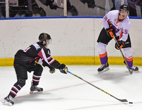 YOUNGSTOWN, OHIO _ DECEMBER 2, 2015: Matt Miller #50 of the Phantoms passes the puck to a teammate while being pressured by Graham Lilibridge #4 of the Lumberjacks during the 1st period of their game Wednesday morning at the Covelli Center. The Phantoms won 6-5 in OT. DAVID DERMER | THE VINDICATOR
