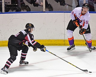 YOUNGSTOWN, OHIO _ DECEMBER 2, 2015: Matt Miller #50 of the Phantoms passes the puck to a teammate while being pressured by Graham Lilibridge #4 of the Lumberjacks during the 1st period of their game Wednesday morning at the Covelli Center. The Phantoms won 6-5 in OT. DAVID DERMER | THE VINDICATOR