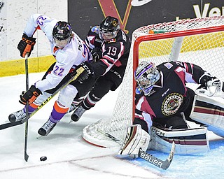 YOUNGSTOWN, OHIO _ DECEMBER 2, 2015: Chase Pearson #22 of the Phantoms skates with the puck behind the net while being trailed by Robbie DeMontis #19 of the Lumberjacks while Joey Accord #29 gets his stick down to prevent a shot on goal during the 1st period of their game Wednesday morning at the Covelli Center. The Phantoms won 6-5 in OT. DAVID DERMER | THE VINDICATOR