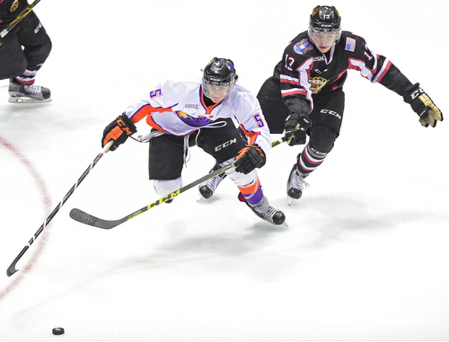 YOUNGSTOWN, OHIO _ DECEMBER 2, 2015: Vas Kolas #5 of the Phantoms skates with the puck up ice while being pursued by Collin Adams #13 of the Lumberjacks during the 2nd period of their game Wednesday morning at the Covelli Center. The Phantoms won 6-5 in OT. DAVID DERMER | THE VINDICATOR