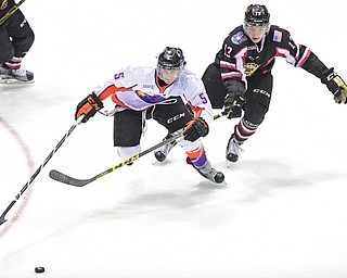 YOUNGSTOWN, OHIO _ DECEMBER 2, 2015: Vas Kolas #5 of the Phantoms skates with the puck up ice while being pursued by Collin Adams #13 of the Lumberjacks during the 2nd period of their game Wednesday morning at the Covelli Center. The Phantoms won 6-5 in OT. DAVID DERMER | THE VINDICATOR