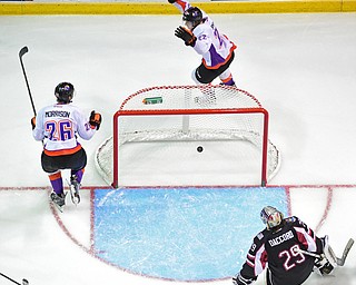 YOUNGSTOWN, OHIO _ DECEMBER 2, 2015: Chase Pearson #22 of the Phantoms celebrates behind the net with teammate Cameron Morrison #26 after scoring a goal on Joey Accord #29 of the Lumberjacks during the 3rd period of their game Wednesday morning at the Covelli Center. The Phantoms won 6-5 in OT. DAVID DERMER | THE VINDICATOR