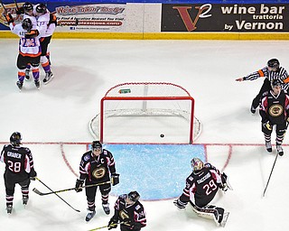 YOUNGSTOWN, OHIO _ DECEMBER 2, 2015: Chase Pearson #22 of the Phantoms celebrates behind the net with teammates Cameron Morrison #26 and Alex Esposito #26 while Joey Accord #29, Will Graber #28, Trevor Hamilton #11, Bobby Kaiser #14 and Zach Berzolla #8 of the Lumberjacks show their frustration during the 3rd period of their game Wednesday morning at the Covelli Center. The Phantoms won 6-5 in OT. DAVID DERMER | THE VINDICATOR