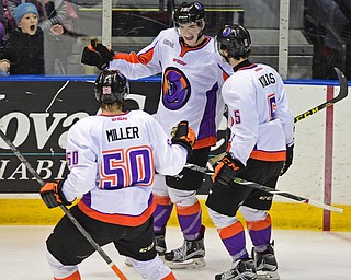 YOUNGSTOWN, OHIO _ DECEMBER 2, 2015: Kevin Conley #10 of the Phantoms celebrates with teammates Vas Kolas #5 and Matt Miller #50 after scoring the game winning goal in overtime of their game Wednesday morning at the Covelli Center. The Phantoms won 6-5 in OT. DAVID DERMER | THE VINDICATOR