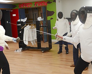 Katie Rickman | The Vindicator.Kathy Durrell, the instructor of the fencing class, on left practices with Forrest Lytell of austintown as other participants watch during a fencing class at Austintown Senior Center on Thursday, November 12, 2015.