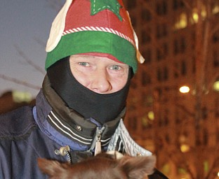 William D. Lewis The Vindicator Doug Sherl of Youngstown donned a Christmas hat while watching the 2015 Christmas Parade in Youngstown with his dog Baby Bear.