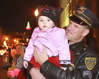 William D. Lewis the Vindicator  YPD Sgt William Ward holds his daughter AvaJean Ward, 1, during 2015 Youngstown Christmas Parade 12-4-15.