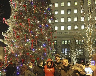 William d Lewis The Vindicator 2015 Younstown ChristmasParade12-4-15.Posing for a pix near the City Christmas tree Friday 12-4-15 are from left:Leanna Hartsough, Heidi Van Auker, David Benko and Richard Bucurel. Taking the pix is Lana Van Auker.