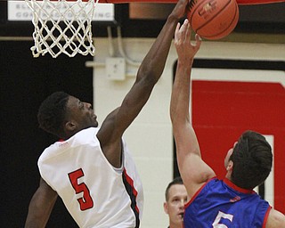 William d Lewis The Vindicator YSU'sSydney Umude(5) blocks a shot from)   American's Marko Vasic(5) during 12-4-15 action at YSU.