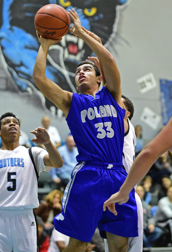 YOUNGSTOWN, OHIO - DECEMBER 4, 2015: William Chammas #33 of Poland is fouled while going to the basket by Moises Dumeng #30 of East during the 2nd half of their game Friday night at East High School. DAVID DERMER | THE VINDICATOR