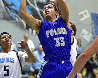 YOUNGSTOWN, OHIO - DECEMBER 4, 2015: William Chammas #33 of Poland is fouled while going to the basket by Moises Dumeng #30 of East during the 2nd half of their game Friday night at East High School. DAVID DERMER | THE VINDICATOR