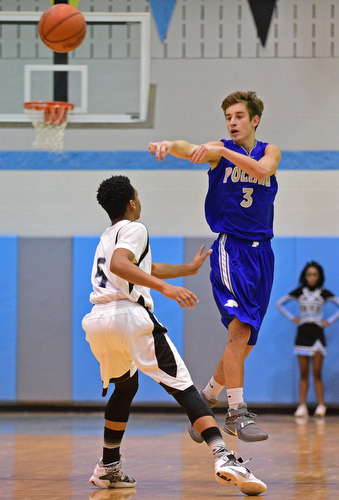 YOUNGSTOWN, OHIO - DECEMBER 4, 2015: Mike Gajdos #3 of Poland flies through the air while passing the ball to a teammate over Ceandre Backus #5 of East during the 2nd half of their game Friday night at East High School. DAVID DERMER | THE VINDICATOR