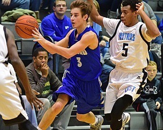 YOUNGSTOWN, OHIO - DECEMBER 4, 2015: Mike Gajdos #3 of Poland passes the ball to a teammate while being pressured from behind by Ceandre Backus #5 of East during the 2nd half of their game Friday night at East High School. DAVID DERMER | THE VINDICATOR