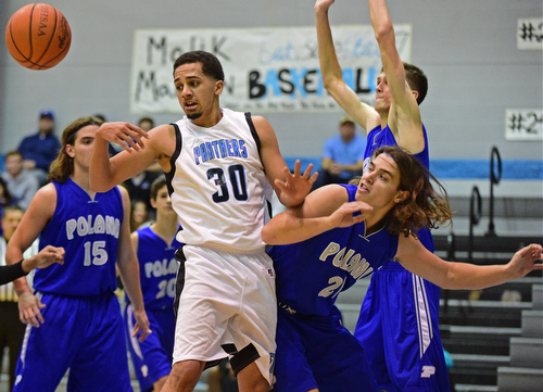 YOUNGSTOWN, OHIO - DECEMBER 4, 2015: Moises Dumeng #30 of East loses control of the basketball while being bumped by Jake Burkert #21 of Poland during the 2nd half of their game Friday night at East High School. DAVID DERMER | THE VINDICATOR