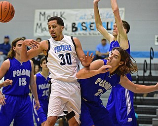 YOUNGSTOWN, OHIO - DECEMBER 4, 2015: Moises Dumeng #30 of East loses control of the basketball while being bumped by Jake Burkert #21 of Poland during the 2nd half of their game Friday night at East High School. DAVID DERMER | THE VINDICATOR