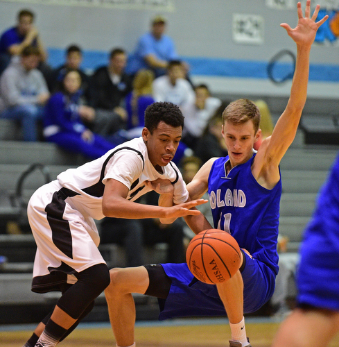 YOUNGSTOWN, OHIO - DECEMBER 4, 2015: Ceandre Backus #5 of East collides with Matt Baker #11 of Poland while he gains possession of the basketball during the 2nd half of their game Friday night at East High School. DAVID DERMER | THE VINDICATOR