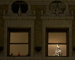 William d Lewis The Vindicator  A christmas tree is shown in hte window of a downtown apartment building.