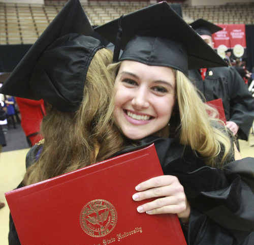 William D. Lewis the Vindicator YSU fashion merchandising grad  Madison Richards gets a hug from one of her professors Dr. Taci Turel during YSU commencement 12132015.