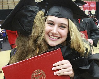 William D. Lewis the Vindicator YSU fashion merchandising grad  Madison Richards gets a hug from one of her professors Dr. Taci Turel during YSU commencement 12132015.