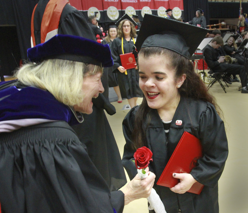William D. Lewis the Vindicator Madison Goske of Canfield gets a rose from one of her professors Dr. Thelma Silver during 12132015 commencement. Goske 's degree was  bachelor of social work.